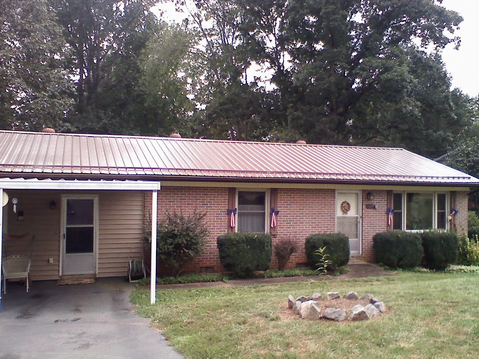 Bronze metal roof and carport on a brick ranch home — Roof Repair work by our crew in Murfreesboro