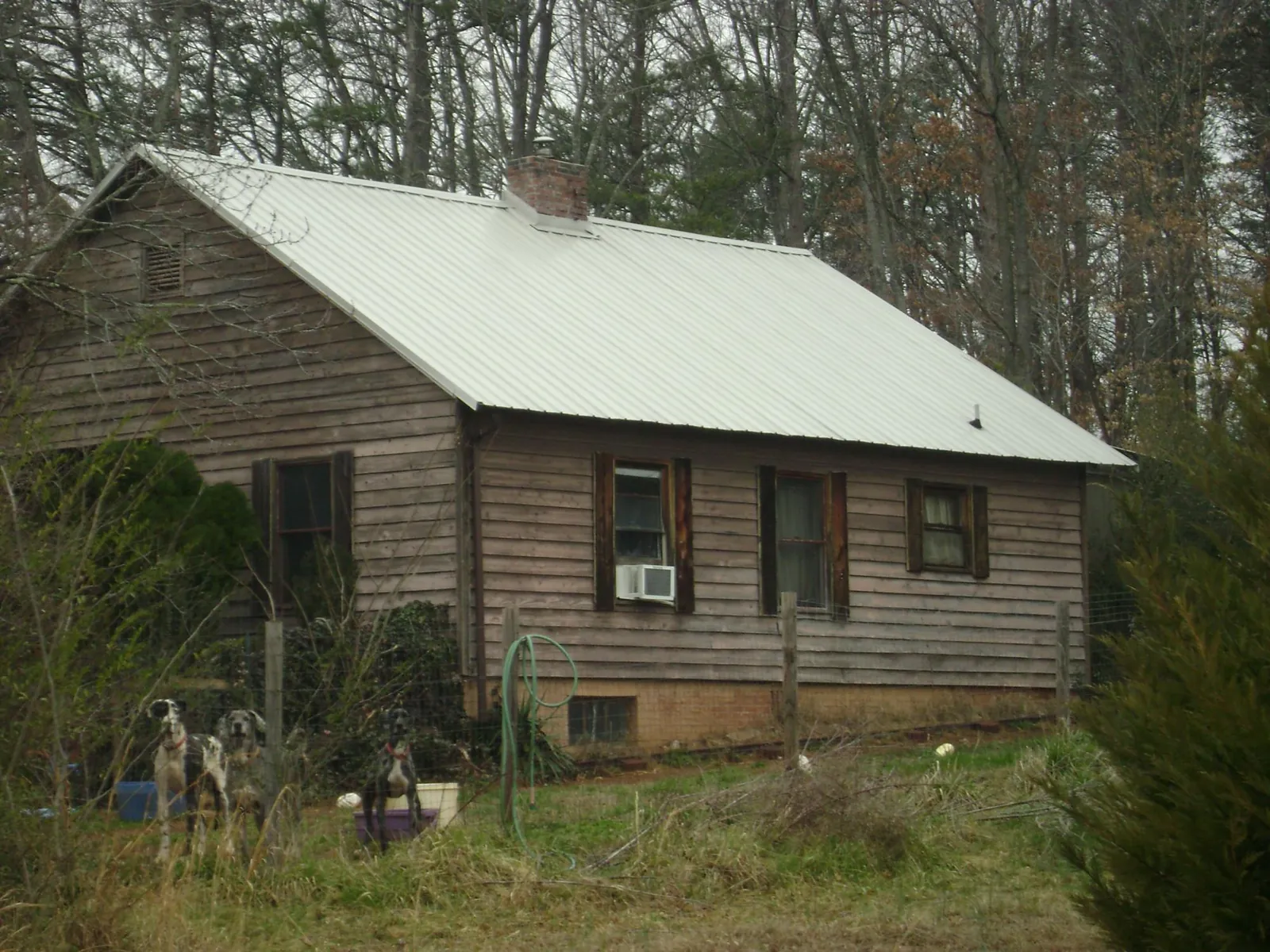 White metal roof on an old wood sided farmhouse, from a Asphalt Shingle Roof Repair job in Murfreesboro